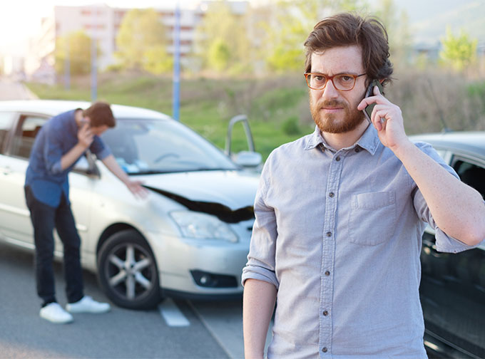 men calling insurance after fender bender