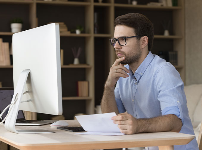 man reviewing financial information on computer