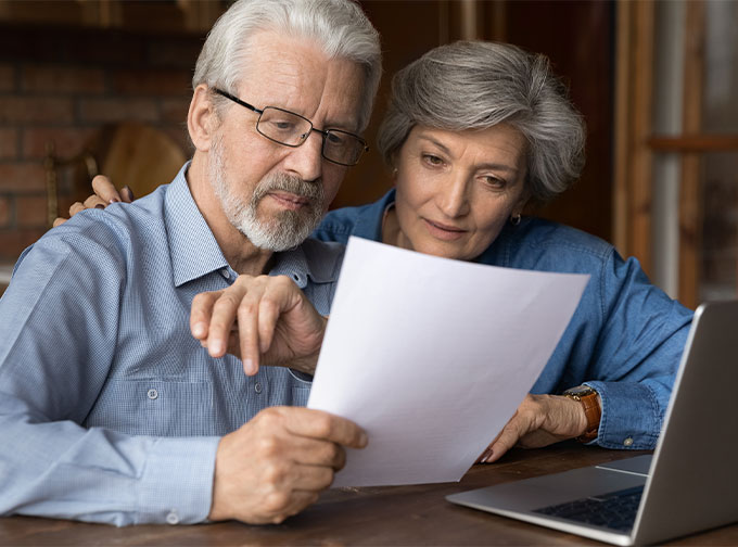 older couple reviewing financial documents