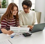 young couple reviewing savings