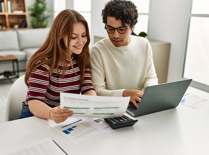 young couple reviewing savings